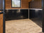 HDPE horse stall wall liner installed around a stall corner with wood upper walls
