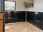 HDPE stall wall liner installed across two adjoining horse stalls with a grain feeder
