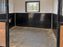 HDPE stall wall liner installed in a white-paneled stall corner with a water bucket
