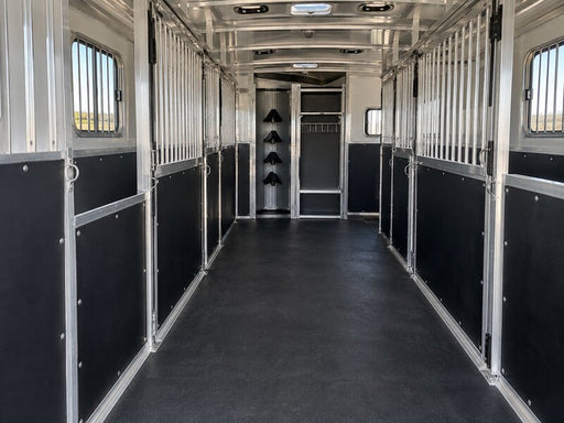 Horse trailer wall liner lining a stall hallway leading to a tack storage area
