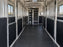 Horse trailer wall liner lining a stall hallway leading to a tack storage area
