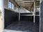 Black wall liner installed in a horse trailer tack storage compartment
