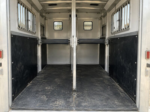 Black HDPE horse trailer wall liner installed in a two-horse trailer with a center divider
