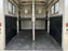 Black HDPE horse trailer wall liner installed in a two-horse trailer with a center divider
